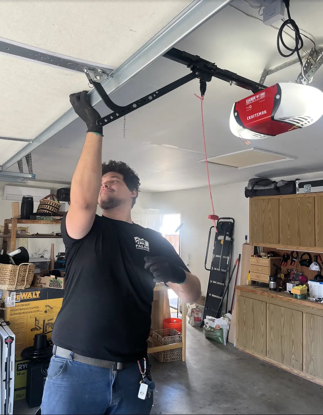 Palms Garage Doors technician servicing a garage door opener